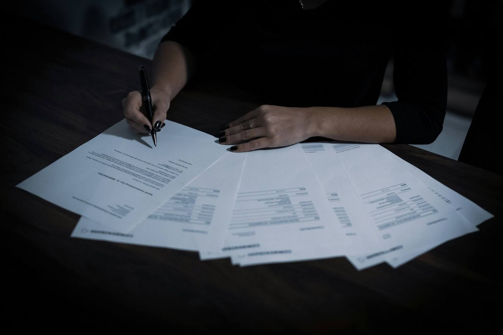 Person Filling Out Paperwork For Valuation Date
