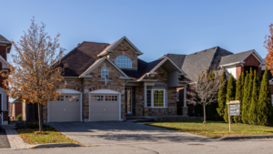Brown two-story brick house with a double-car garage