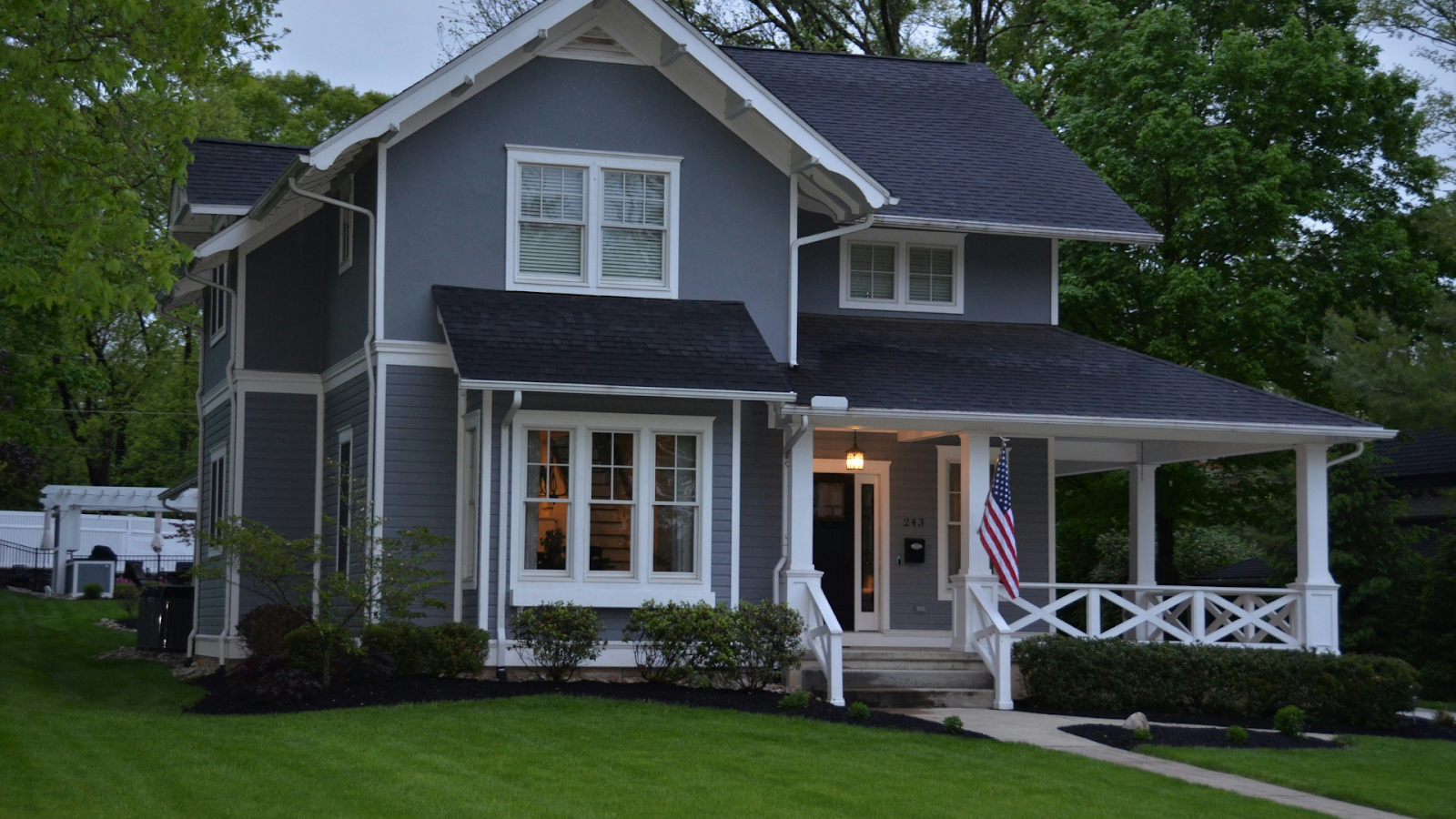 Historic 2-story gray house with white trimming