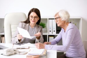 A Texas Tax Protest professional teaching her client what really happens during a property tax protest hearing on a piece of paper.
