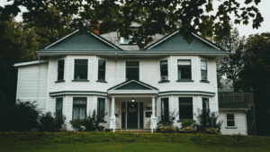 Three-Story White And Green Wooden Home