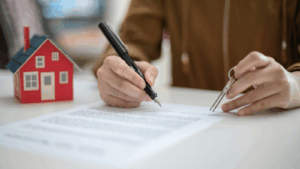 Person reviewing a contract with a key in hand