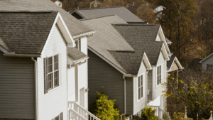 Row of gray homes with white trimming on a suburban road