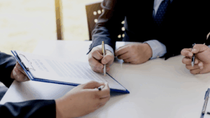 Two people about to sign a non-disclosure agreement