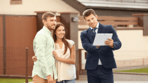 Assessor pointing something at his tablet outside homeowners’ property